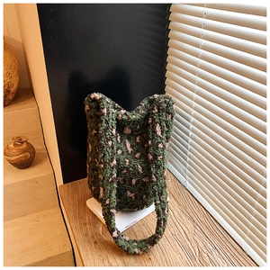 Detail of green leopard print sherpa fleece bucket bag with soft texture and wide handle