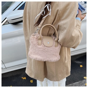 Detailed shot of pink plush bag with khaki leather trim and silver metal hardware accents