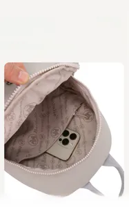 Internal view of the lightweight backpack showing pink logo lining and a zipper pocket
