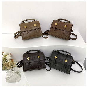 Detail view of four vintage matte leather mini crossbody bags in earthy tones