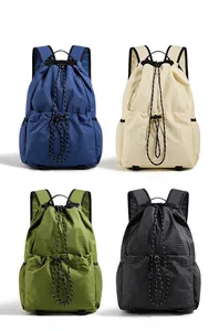 Detail view showing drawstring backpacks in blue, beige, green, and black colors