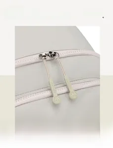 Close-up of smooth double zippers with Baolujie brand pullers on grey nylon backpack