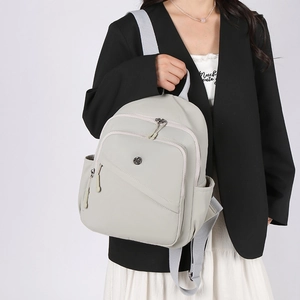 Detail of high-density waterproof nylon fabric on light grey minimalist backpack for women