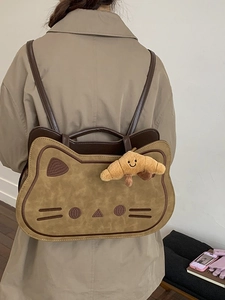 Cute caramel toast cat-shaped backpack with cat ears and croissant charm in retro style