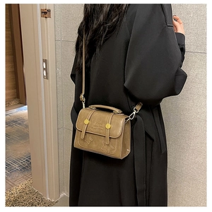 Detail of khaki leather crossbody bag with star stitching and happiness embossed text