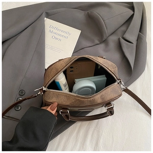 Internal view of brown retro Boston bag showing spacious storage for daily essentials