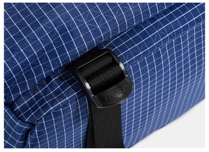 Detail of blue grid ripstop fabric with black plastic adjustment buckle and CLBD logo