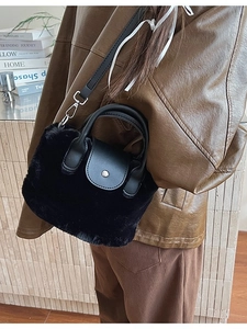 Chic black faux fur mini bucket bag with leather handle and adjustable shoulder strap