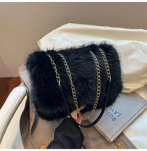 Close-up of black faux fur plush tote bag with elegant golden metal chain strap