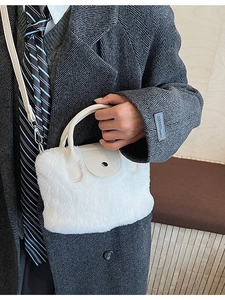 White faux fur bucket bag with beige leather handle and silver metal snap button closure