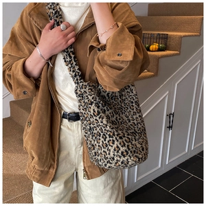 Detail of leopard print plush bucket bag featuring soft faux fur texture and large capacity