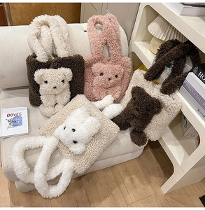 Three plush teddy bear tote bags in white, pink, and brown displayed on a cozy sofa