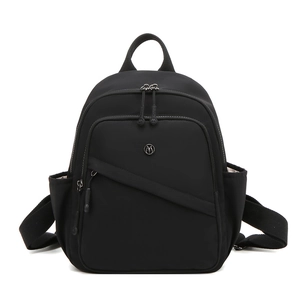 Close-up of the black nylon backpack showing zippers, side pockets, and metallic logo detail