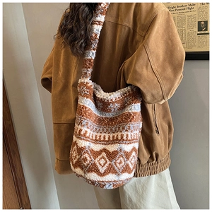 Close-up of retro bucket bag featuring brown and cream plush fabric with geometric patterns