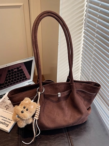 Retro dark brown bucket tote bag with plush puppy charm and pleated minimalist design