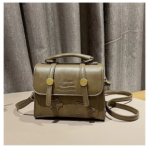 Detail of dark olive green PU leather bag with gold rivets and logo embossing