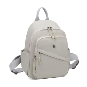 Close-up of light gray lightweight nylon backpack with multiple zipper compartments