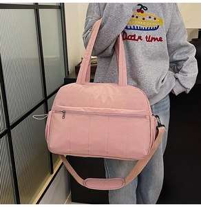 Pink large travel bag detail with front zipper and adjustable shoulder strap