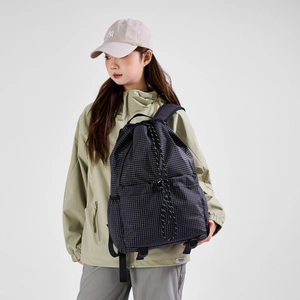 Detailed view of lightweight black plaid drawstring backpack with side mesh pockets