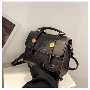 Detail of vintage faux leather handbag with star embossing and metal buckles