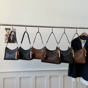 Minimalist leather shoulder bags with wooden bead tassels in assorted earth tones