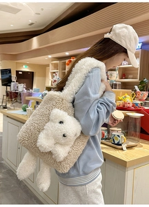 Close-up of a cozy beige faux fur tote bag with a 3D white teddy bear in a warm cafe setting