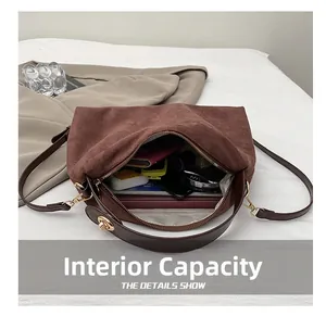 Internal capacity of brown matte crossbody bag showing laptop and makeup items