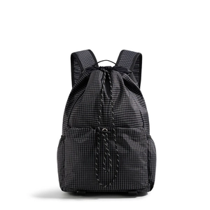 Detailed view of the durable black grid ripstop fabric and adjustable drawstrings of this backpack