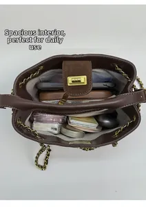 Top view of spacious interior of dark brown bucket bag with gold chain strap