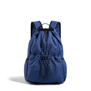 Close-up of blue grid pattern drawstring backpack featuring durable nylon fabric and side pockets