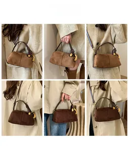 Chic suede Boston bag with horseshoe metal buckle in versatile crossbody styling