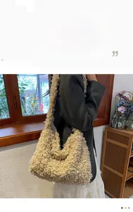 Detailed close-up of fluffy khaki faux shearling hobo bag with curly plush texture