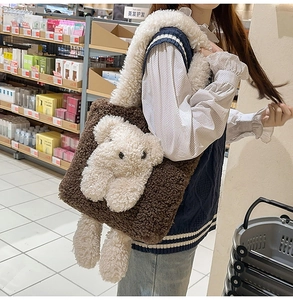 Close-up of brown plush shoulder bag featuring a 3D white teddy bear decoration
