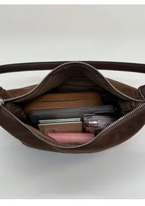 Interior view of the brown suede underarm bag showing ample space for daily essentials