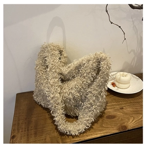 Close-up of cream white teddy fleece tote bag texture on a vintage wooden table