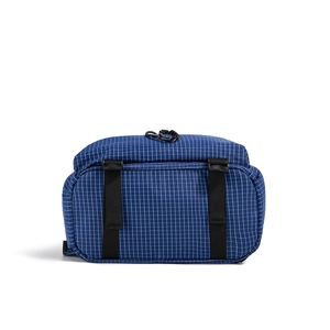 Detail of navy blue checkered drawstring backpack with tear-resistant nylon texture