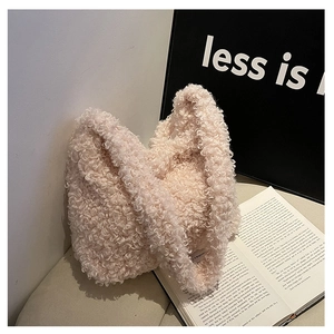 Close-up of soft pink faux shearling texture and minimalist design on a tote bag
