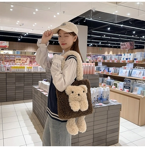 Detail of soft brown plush tote bag with a cute 3D beige teddy bear and fuzzy handle