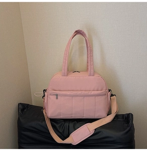 Pink travel bag with double handles and adjustable padded shoulder strap for fitness and travel