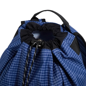 Detailed macro view of the ripstop grid fabric and drawstring closure on top of the bag