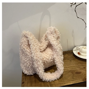 Detailed view of plush teddy fabric texture on creamy white oversized shoulder tote bag