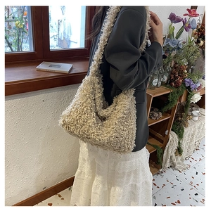 Detail of off-white plush lamb wool shoulder bag showing soft curly faux fur texture