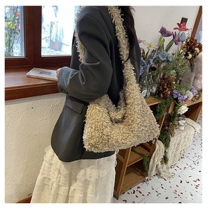 Close-up of beige plush tote bag in faux lamb wool texture worn with casual outfit