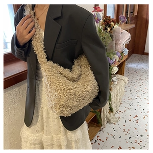 Detail of soft beige teddy plush tote bag with curly faux fur texture and matching strap