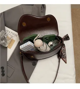 Deep brown saddle bag interior showing large capacity for essentials with magnetic clasp