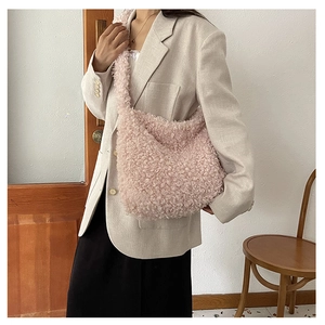 Detail view of pink plush crossbody tote bag with wide strap and soft faux fur texture