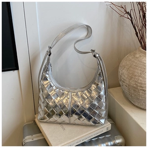 Detail der silbernen gewebten Hobo-Tasche mit verstellbarem Gurt auf Display-Set