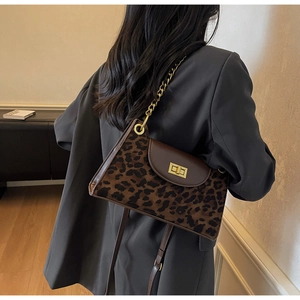 Detail view of retro leopard print handbag with gold chain strap and metal twist-lock