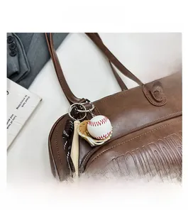 Brown PU leather tote bag detailing with embossed letters and baseball charm accessories