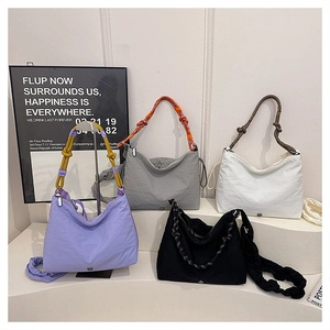 Detailed display of four colorful nylon crossbody bags with knot rope shoulder straps